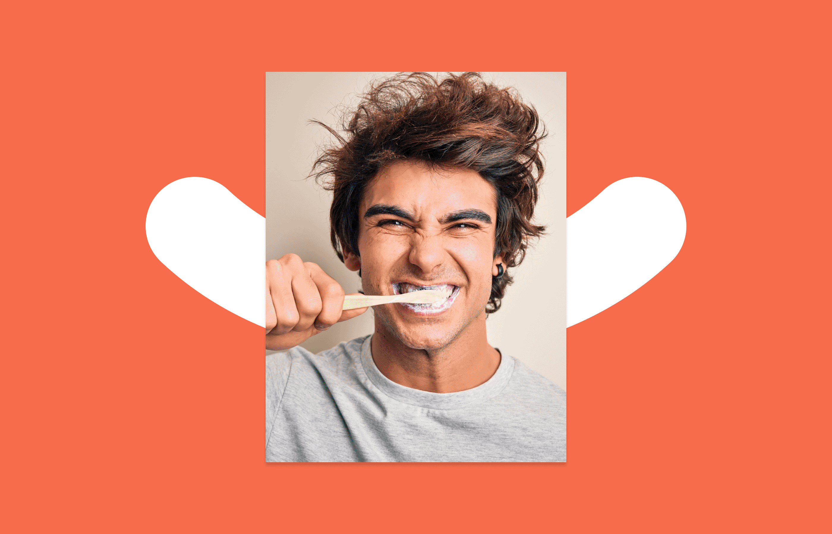 GIF of two alternating images. The first is of a man with brown hair and a gray sweater brushing his teeth. The man has a smile on his face. The second photo is of the same man with the toothbrush in a different place in his mouth. The alternation of the
