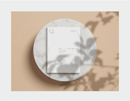 High-end stationery design for the Quintessence Hotel in Tremblant, including a letterhead with the gold logo embossed on a beige background.