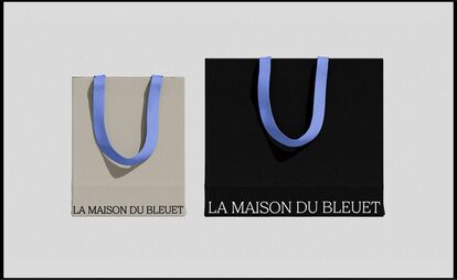Two shopping bags side by side on a gray background. On the left, a beige bag with blue handles and the 